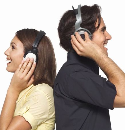 Man and woman wearing headphones